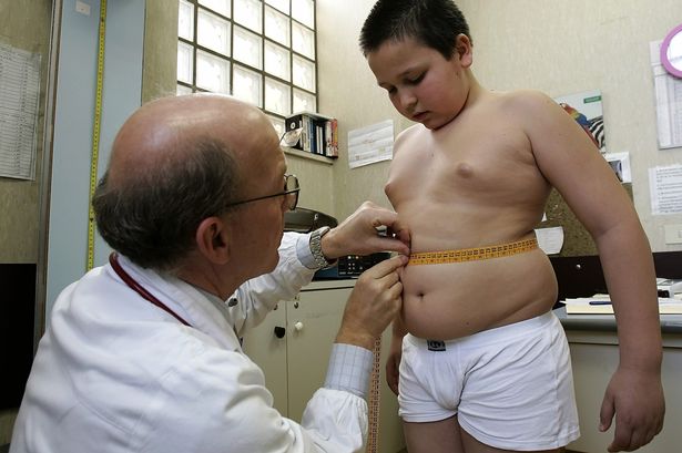 Obese+Ten+year+old+boy+inspected+by+a+doctor